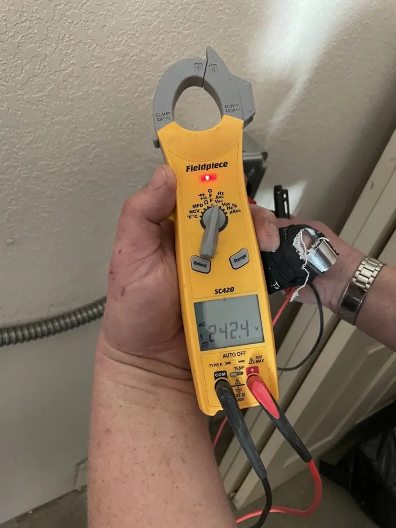 Voltage testing with clamp meter during Whole House Surge Protector in Louisville